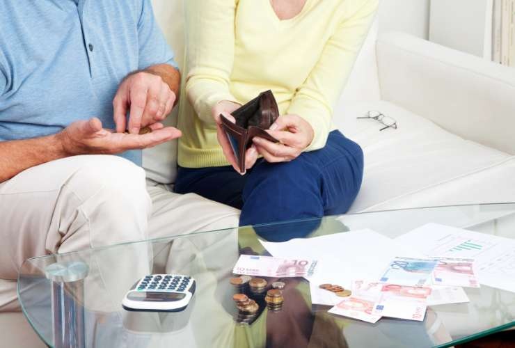 persone sedute sul divano che contano i soldi