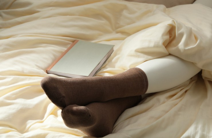 donna che sta a letto con i calzini 