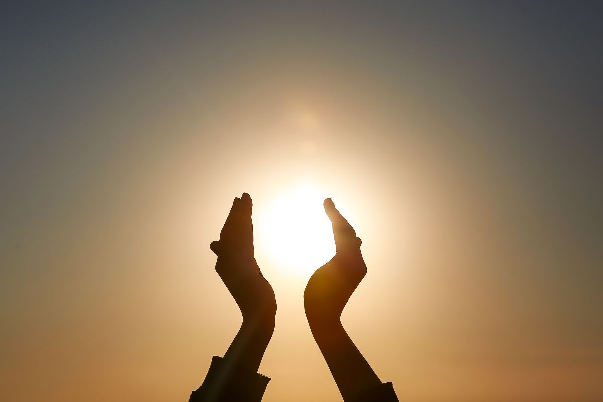 Mani che racchiudono la luce del Sole