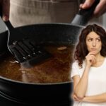 padella con olio esausto e donna pensierosa